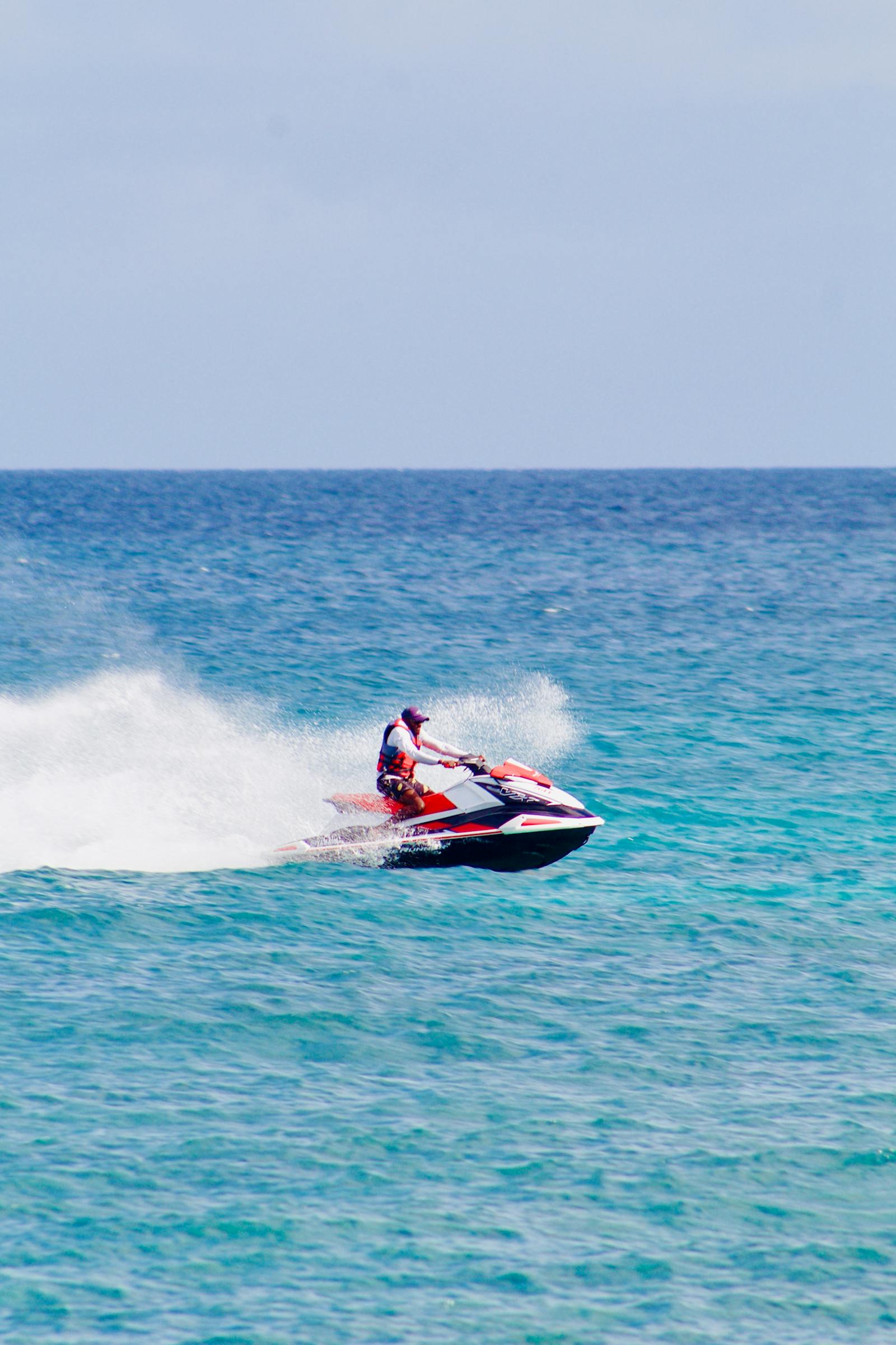 Man on jet ski surrounded by sea spray